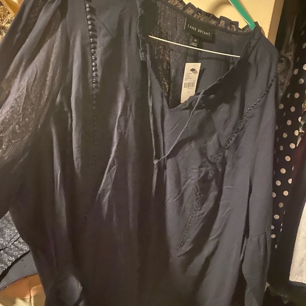 New with tags Lane Bryant Navy blouse with cutout sleeve detail.